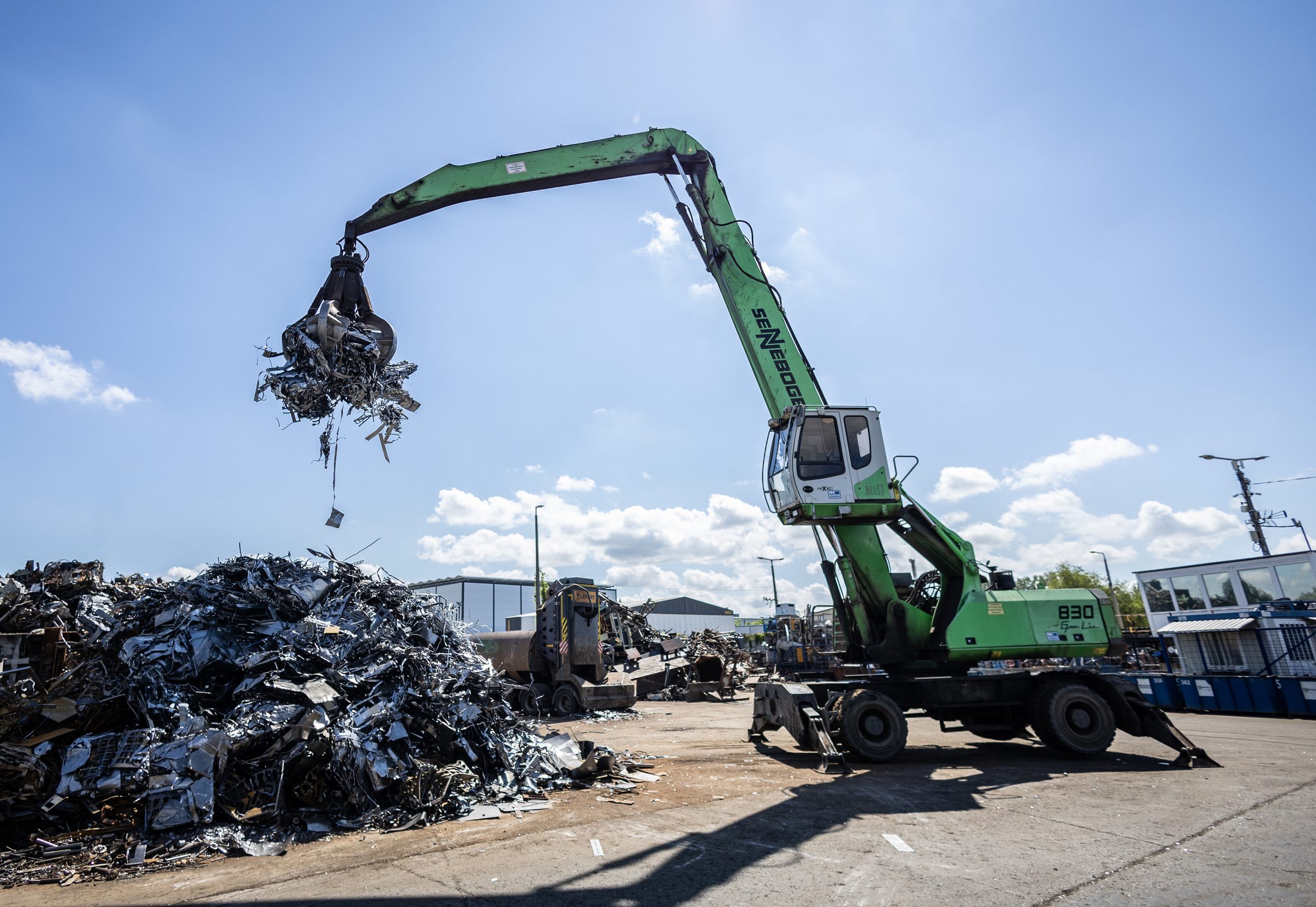 Material handler crane loading scrap metal at the Metal-For yard